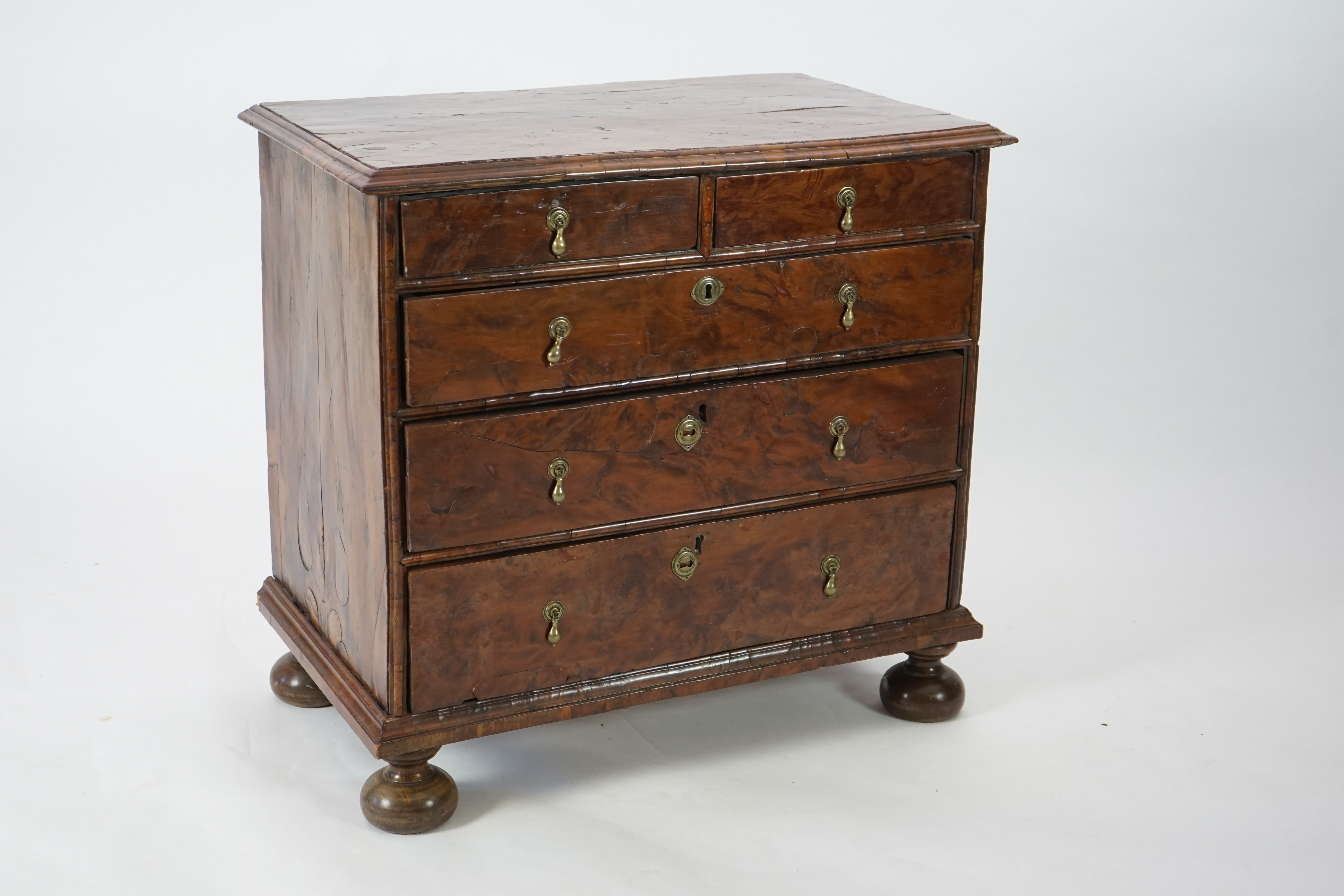 An early 18th century and later yew wood veneered oak chest